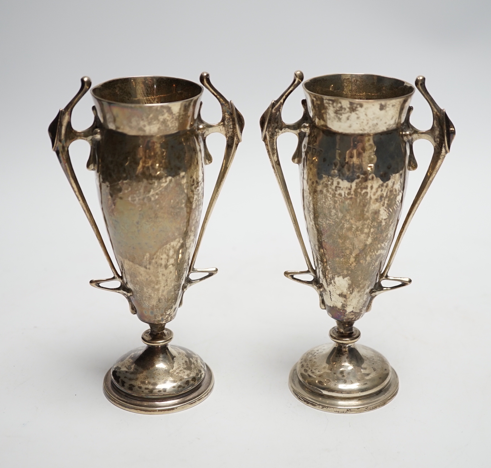 A pair of Edwardian Art Nouveau silver two handled posy vases, Charles Edwards, London, 1905, 16cm, 8oz.